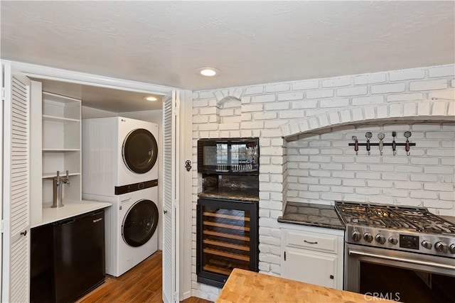 washroom featuring dark hardwood / wood-style flooring, beverage cooler, and stacked washer and clothes dryer