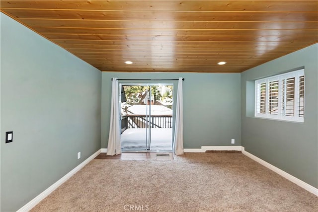 spare room with carpet floors and wooden ceiling