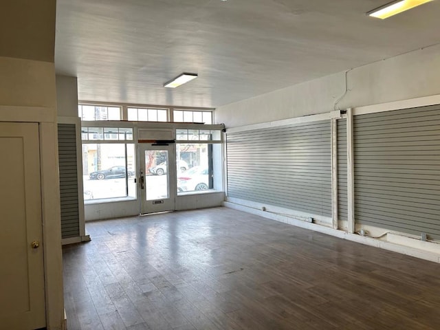 spare room with dark hardwood / wood-style floors and french doors