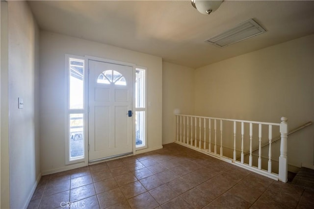 tiled foyer entrance featuring a healthy amount of sunlight