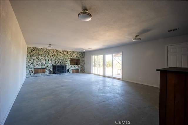 unfurnished living room featuring concrete flooring and a fireplace