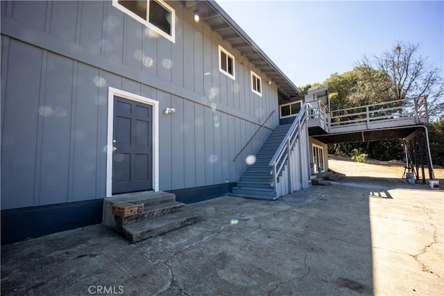 entrance to property with a patio and a wooden deck