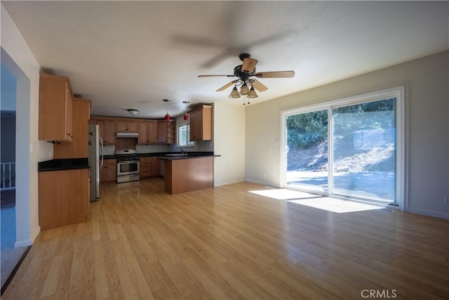 kitchen with ceiling fan, kitchen peninsula, light hardwood / wood-style floors, pendant lighting, and appliances with stainless steel finishes