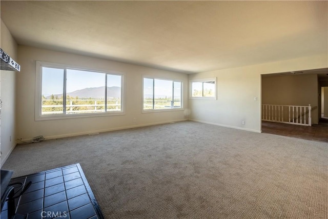 carpeted spare room featuring a mountain view