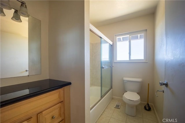 full bathroom with tile patterned flooring, vanity, toilet, and enclosed tub / shower combo