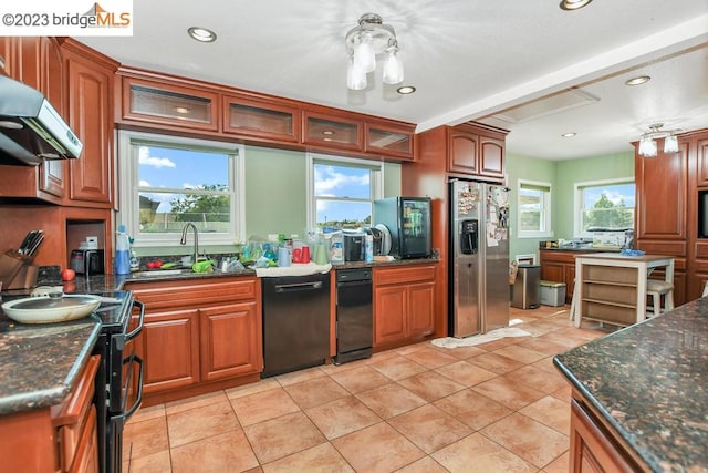 kitchen with dishwasher, stainless steel fridge with ice dispenser, wall chimney exhaust hood, and a wealth of natural light