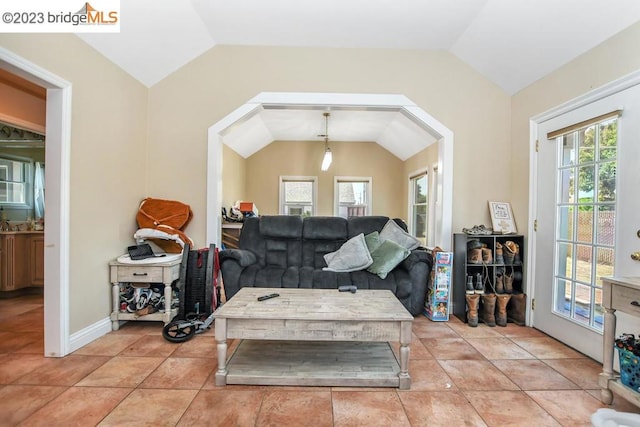 tiled living room featuring lofted ceiling