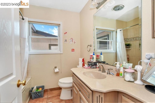 bathroom featuring toilet, tile floors, and vanity