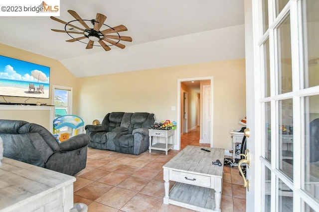 tiled living room with lofted ceiling and ceiling fan