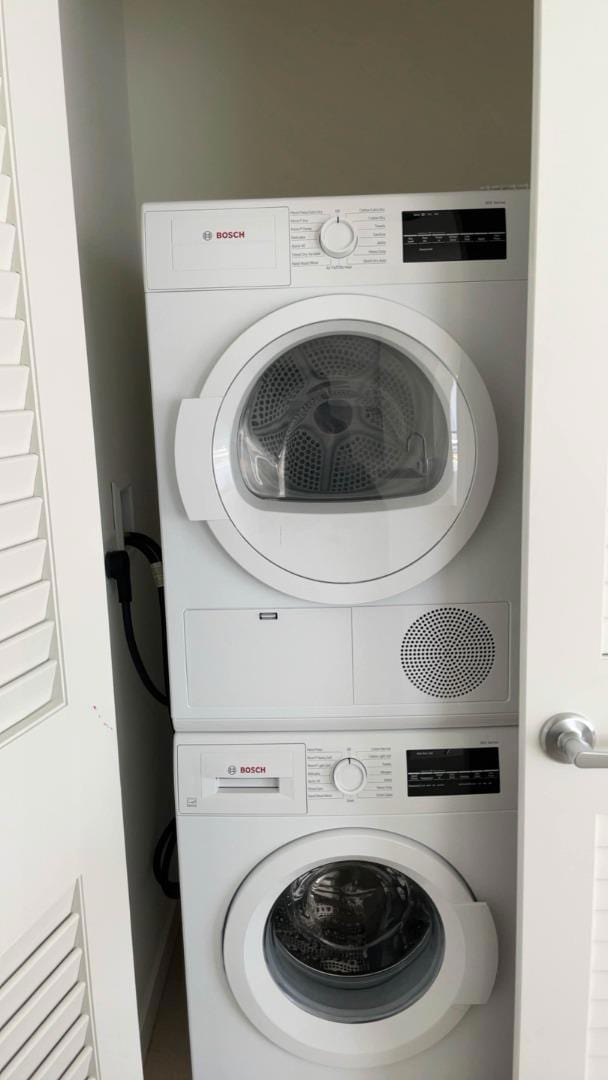 laundry area with stacked washer and clothes dryer