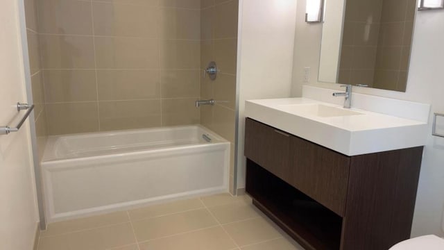 bathroom featuring tile patterned floors, vanity, and tiled shower / bath combo