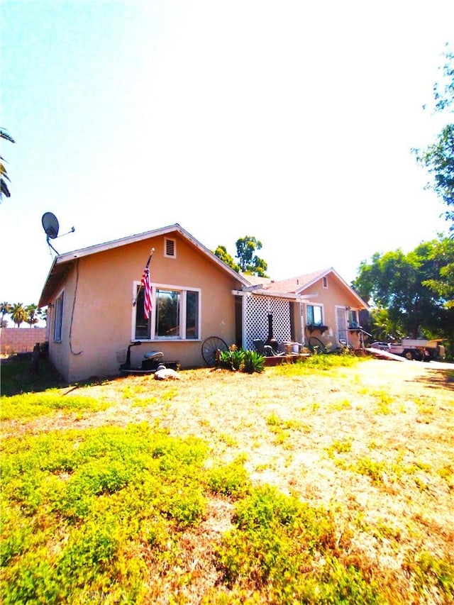 rear view of house with a yard