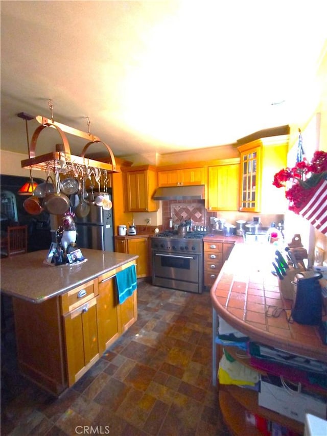 kitchen featuring black refrigerator and high end stove