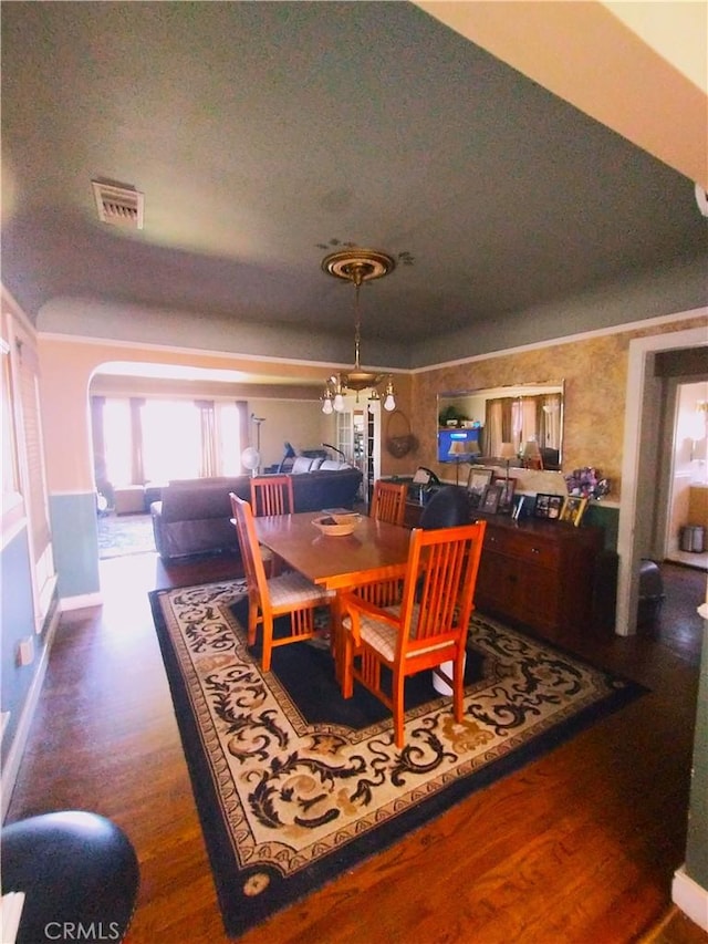 dining area featuring a chandelier, a textured ceiling, and dark hardwood / wood-style flooring