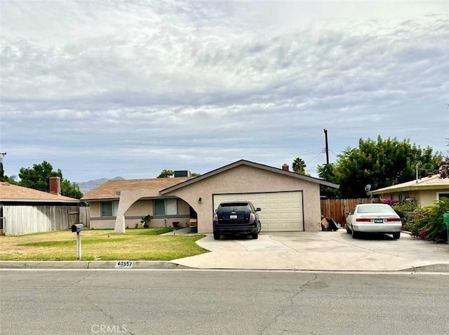 single story home with a garage and a front lawn