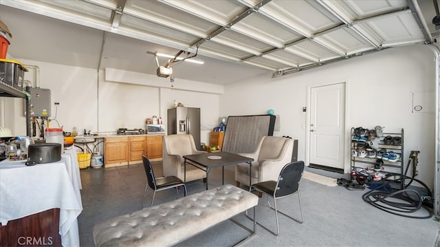 garage featuring a garage door opener, water heater, and stainless steel refrigerator with ice dispenser