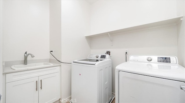 washroom featuring washing machine and clothes dryer and sink