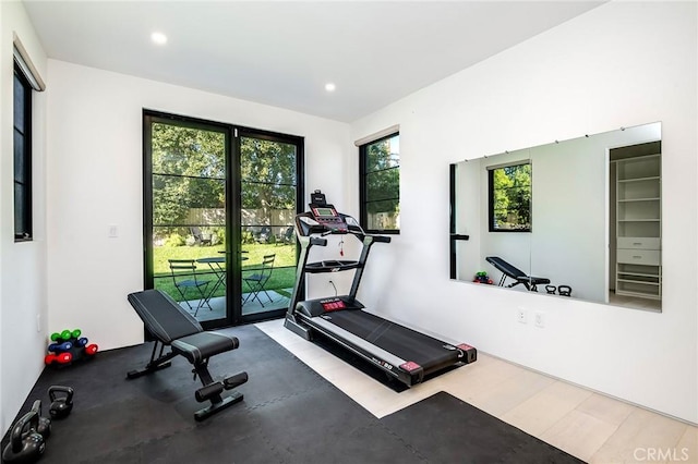 workout room with a healthy amount of sunlight and wood-type flooring