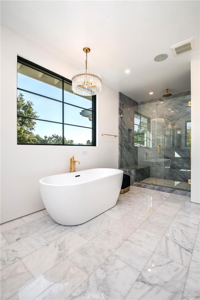 bathroom featuring an inviting chandelier and shower with separate bathtub