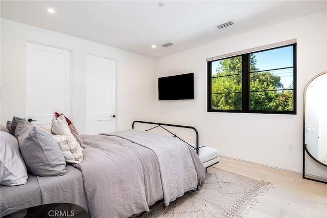 bedroom with light hardwood / wood-style floors