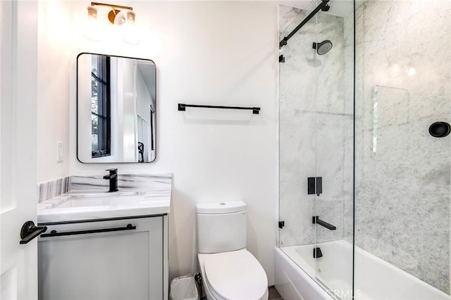 full bathroom with vanity, toilet, and enclosed tub / shower combo