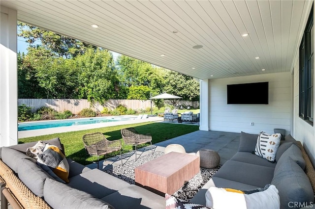 view of patio featuring an outdoor living space and a fenced in pool