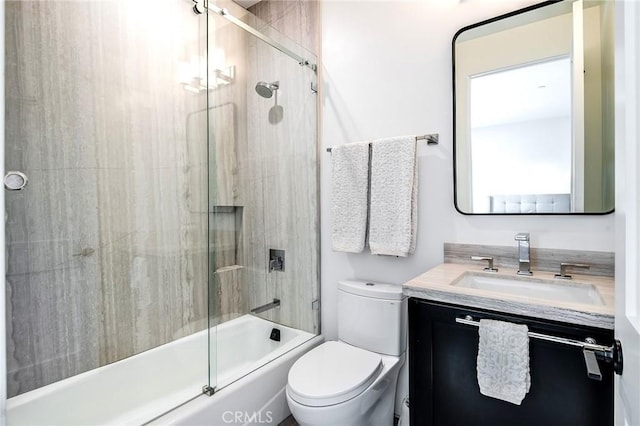 full bathroom with shower / bath combination with glass door, vanity, and toilet