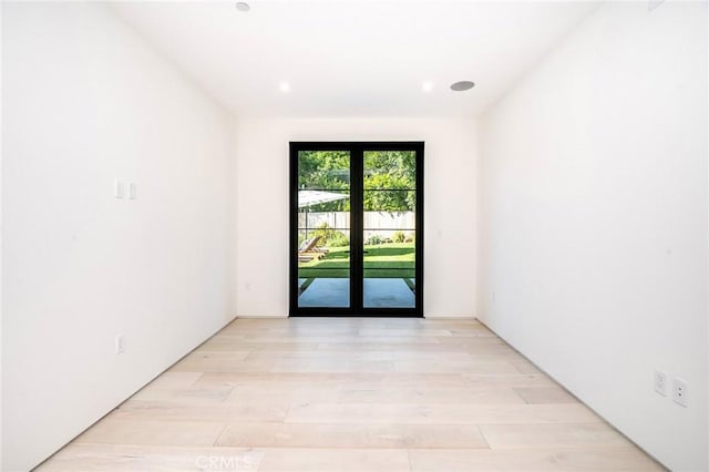 unfurnished room with light wood-type flooring