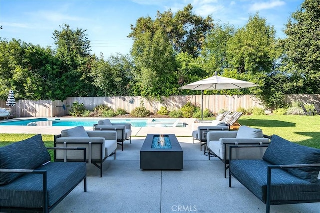 view of patio / terrace featuring a fenced in pool and an outdoor living space with a fire pit