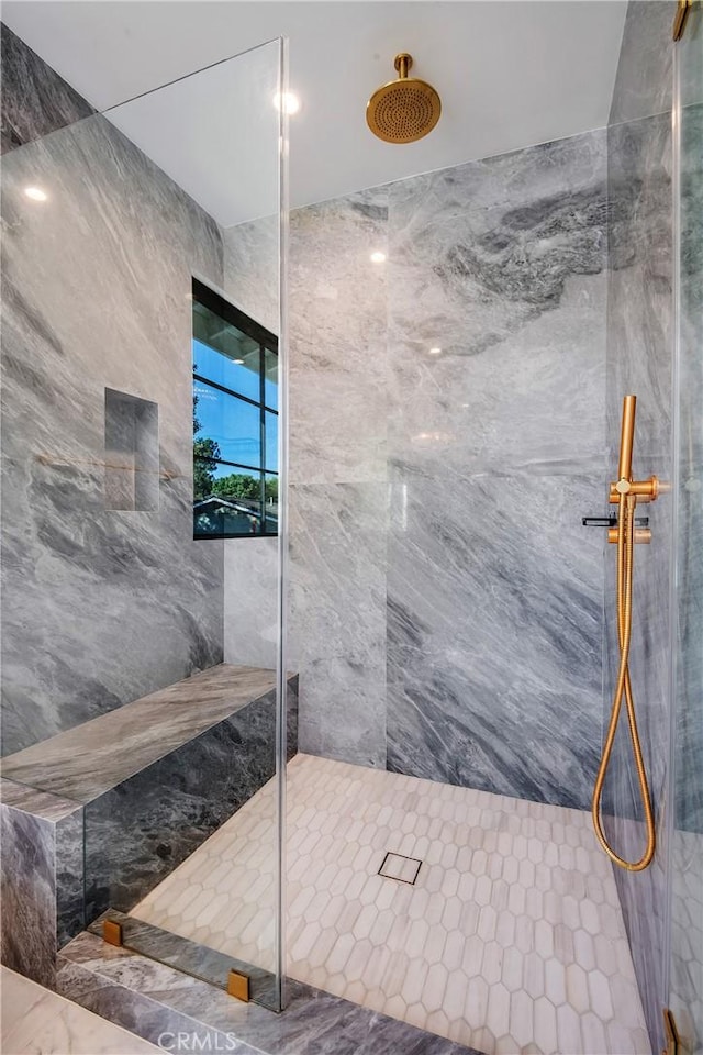 bathroom with tiled shower