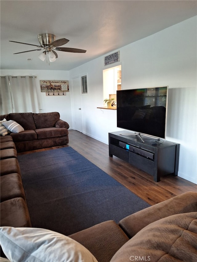 living room featuring dark hardwood / wood-style floors and ceiling fan