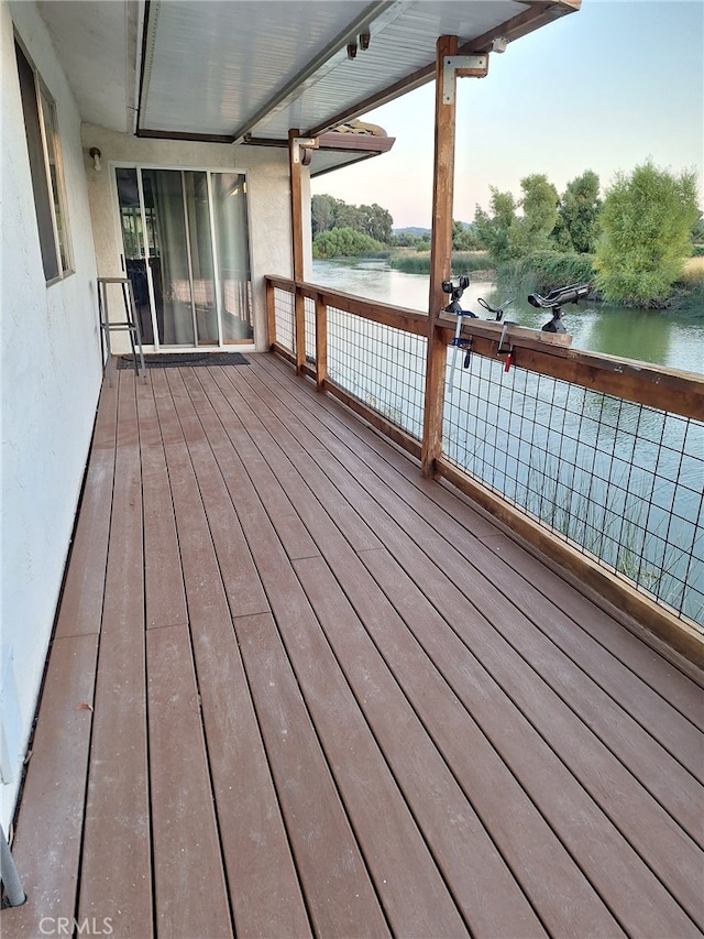 wooden terrace featuring a water view