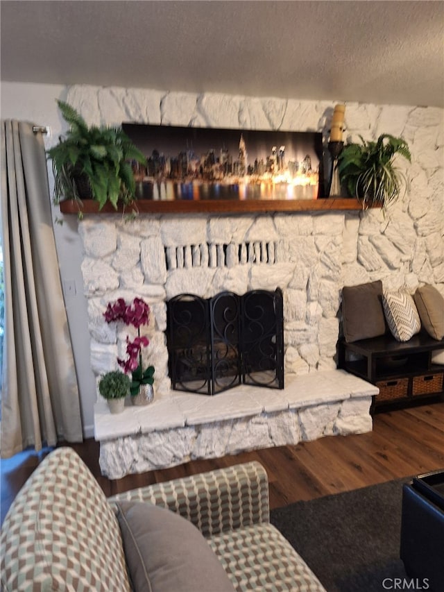 details featuring a fireplace, wood-type flooring, and a textured ceiling