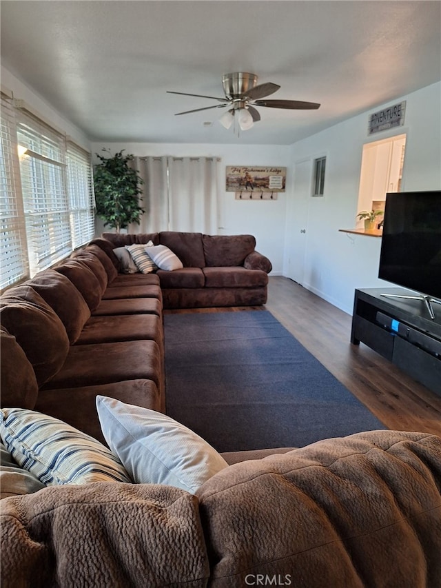 living room featuring dark hardwood / wood-style floors and ceiling fan