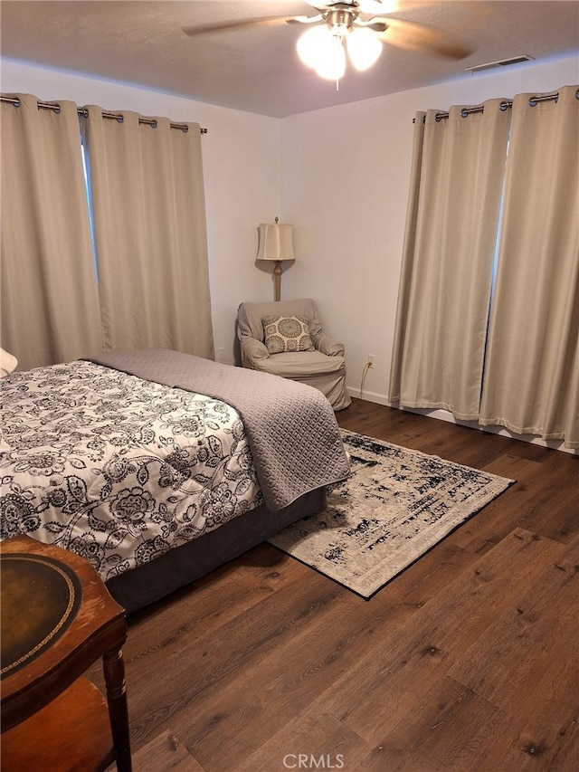 bedroom featuring ceiling fan and dark hardwood / wood-style floors