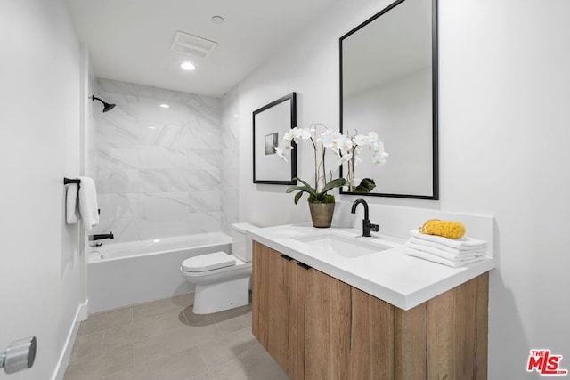 full bathroom with tile patterned flooring, vanity, toilet, and tiled shower / bath