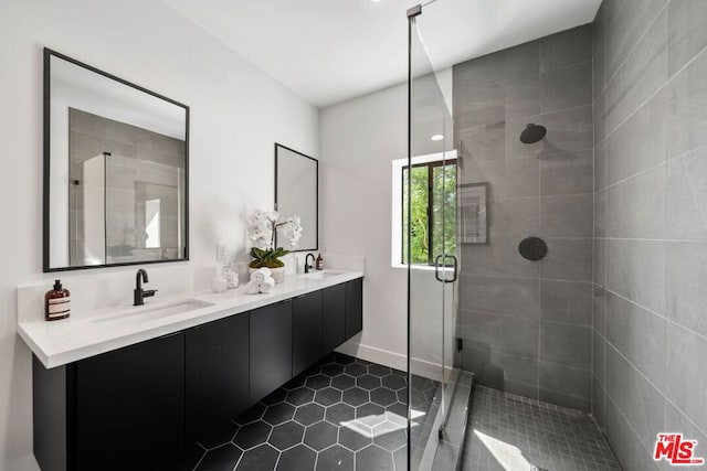 bathroom featuring tile patterned floors, vanity, and a shower with shower door