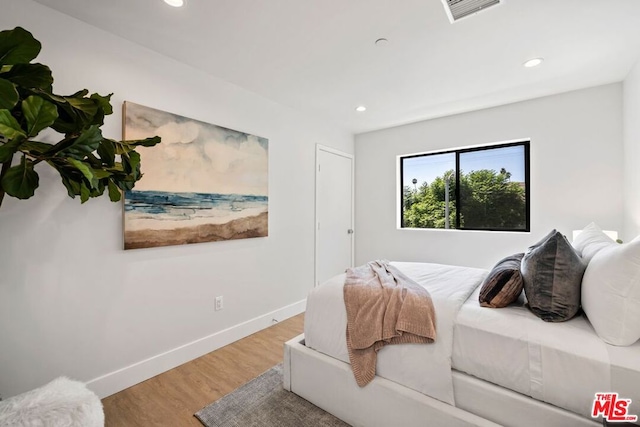 bedroom with hardwood / wood-style flooring