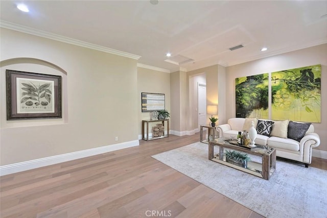 living room with light wood-type flooring and ornamental molding