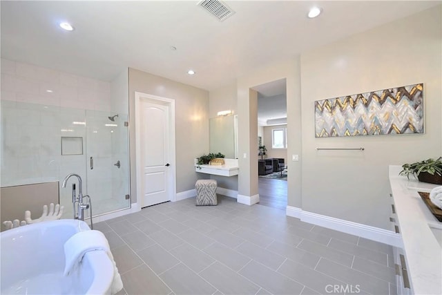 bathroom with tile patterned flooring, vanity, and a shower with door