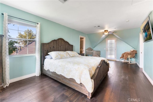 bedroom featuring ceiling fan, dark hardwood / wood-style floors, and lofted ceiling