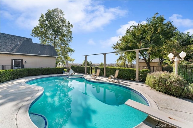 view of pool featuring a diving board and a patio