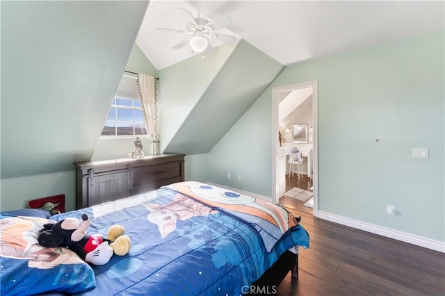 bedroom featuring connected bathroom, ceiling fan, dark wood-type flooring, and vaulted ceiling