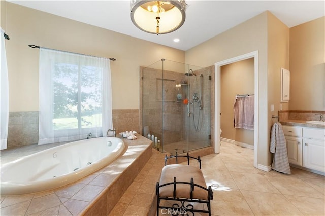 bathroom with tile patterned flooring, shower with separate bathtub, and vanity