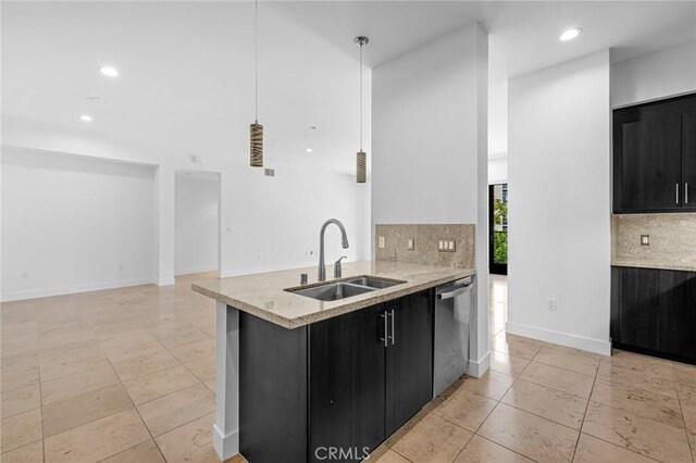 kitchen featuring kitchen peninsula, tasteful backsplash, sink, dishwasher, and hanging light fixtures