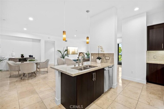 kitchen with decorative backsplash, dark brown cabinetry, sink, pendant lighting, and dishwasher