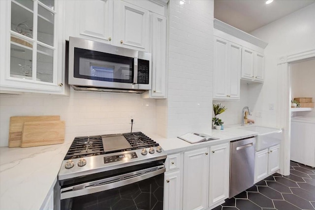 kitchen with sink, white cabinetry, and appliances with stainless steel finishes