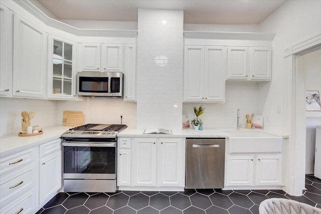 kitchen featuring sink, white cabinetry, backsplash, and stainless steel appliances