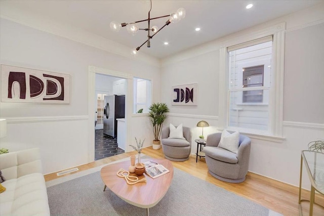 living room with an inviting chandelier and wood-type flooring