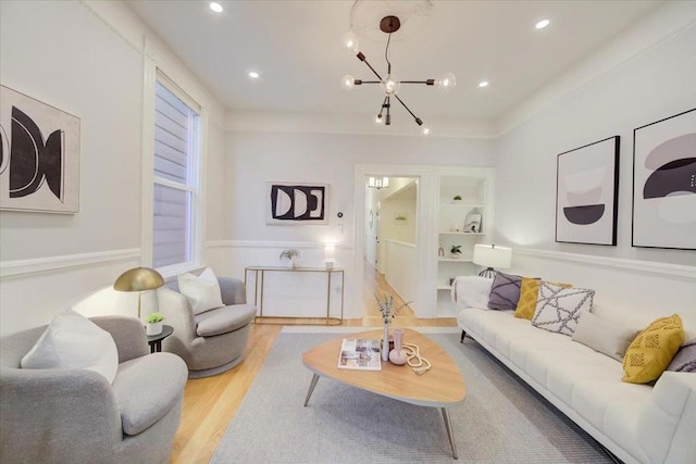 living room featuring a notable chandelier, light hardwood / wood-style floors, and built in shelves